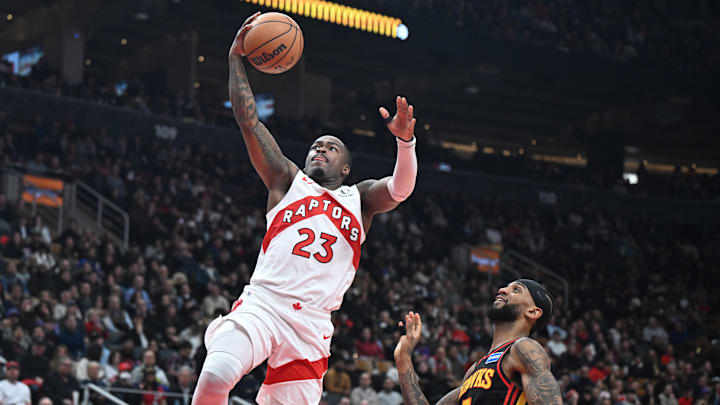 Jan 5, 2026; Toronto, Ontario, CAN;  Toronto Raptors guard Jamal Shead (23) shoots a layup above Atlanta Hawks guard Nickeil Alexander-Walker (7) in the second half at Scotiabank Arena. Mandatory Credit: Dan Hamilton-Imagn Images