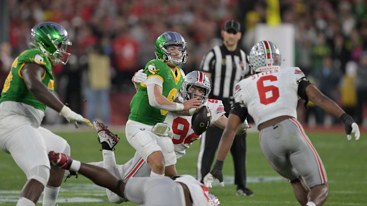 Jan 1, 2025; Pasadena, CA, USA; Oregon Ducks quarterback Dillon Gabriel (8) looks to throw against Ohio State Buckeyes defensive end Caden Curry (92) and safety Sonny Styles (6) in the second half in the 2025 Rose Bowl college football quarterfinal game at Rose Bowl Stadium. Mandatory Credit: Jayne Kamin-Oncea-Imagn Images