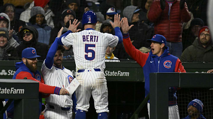 Apr 7, 2025; Chicago, Illinois, USA;  Chicago Cubs third baseman Jon Berti (5) high fives manager Craig Counsell (11) after he scores against the Texas Rangers  during the third inning at Wrigley Field. Mandatory Credit: Matt Marton-Imagn Images