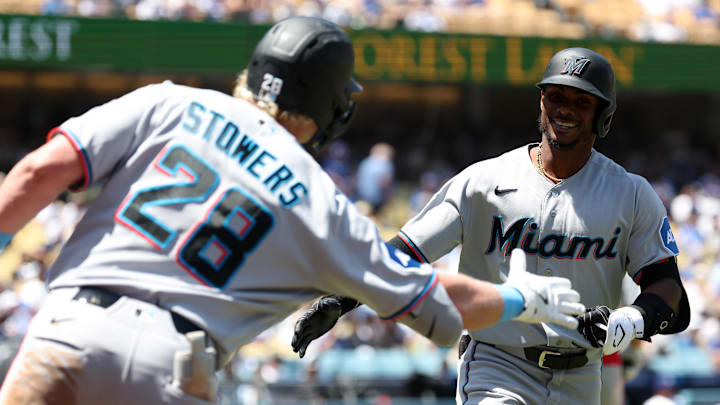 Miami Marlins left fielder Esteury Ruiz (right).