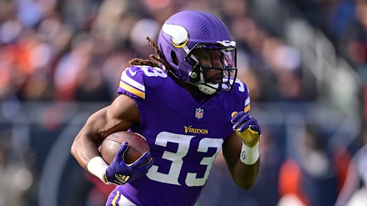 Nov 24, 2024; Chicago, Illinois, USA; Minnesota Vikings running back Aaron Jones (33) runs the ball against the Chicago Bears during the first quarter at Soldier Field. Mandatory Credit: Daniel Bartel-Imagn Images