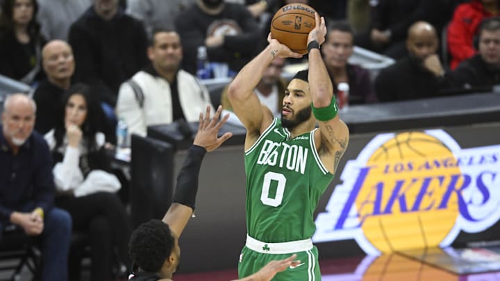 Feb 4, 2025; Cleveland, Ohio, USA; Boston Celtics forward Jayson Tatum (0) shoots against Cleveland Cavaliers guard Donovan Mitchell (45) in the fourth quarter at Rocket Mortgage FieldHouse. Mandatory Credit: David Richard-Imagn Images