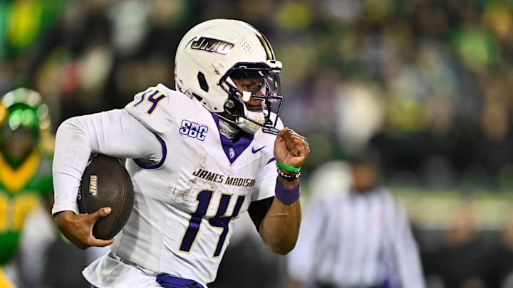Dec 20, 2025; Eugene, OR, USA;  James Madison Dukes quarterback Alonza Barnett III (14) rushes during the fourth quarter against the Oregon Ducks at Autzen Stadium. Mandatory Credit: Craig Strobeck-Imagn Images