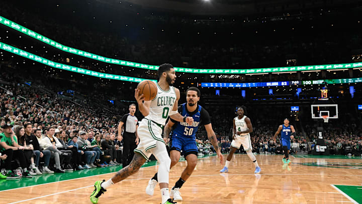 Jan 17, 2025; Boston, Massachusetts, USA; Boston Celtics forward Jayson Tatum (0) passes the ball while defended by Orlando Magic guard Cole Anthony (50) during the second half at TD Garden. Mandatory Credit: Eric Canha-Imagn Images