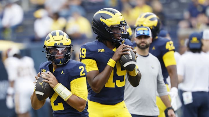 Sep 13, 2025; Ann Arbor, Michigan, USA;  Michigan Wolverines quarterbacks Jadyn Davis (2) and Bryce Underwood (19) warms up before the game against the Central Michigan Chippewas at Michigan Stadium. Mandatory Credit: Rick Osentoski-Imagn Images
