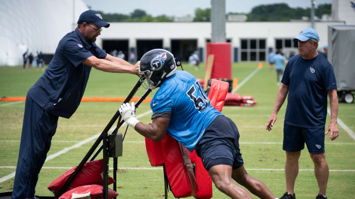 Offensive lineman John Ojukwu (61) hits the sled with offensive line coach Bill Callahan, right, watching during the Tennessee Titans mandatory mini-camp at Ascension Saint Thomas Sports Park in Nashville, Tenn., Wednesday, June 5, 2024. Offensive lineman John Ojukwu (61) hits the sled with offensive line coach Bill Callahan, right, watching during the Tennessee Titans mandatory mini-camp at Ascension Saint Thomas Sports Park in Nashville, Tenn., Wednesday, June 5, 2024.