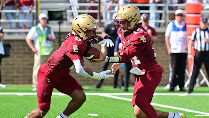 Sep 28, 2024; Chestnut Hill, Massachusetts, USA; Boston College Eagles quarterback Grayson James (14) hands the ball to running back Treshaun Ward (0) during the first half at Alumni Stadium. Mandatory Credit: Eric Canha-Imagn Images