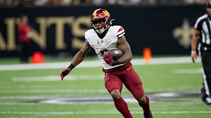 Dec 15, 2024; New Orleans, Louisiana, USA; Washington Commanders running back Brian Robinson Jr. (8) runs against the New Orleans Saints during the first half at Caesars Superdome. Dec 15, 2024; New Orleans, Louisiana, USA; Washington Commanders running back Brian Robinson Jr. (8) runs against the New Orleans Saints during the first half at Caesars Superdome.