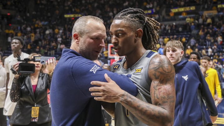 Mar 8, 2025; Morgantown, West Virginia, USA; West Virginia Mountaineers head coach Darian DeVries and guard Javon Small (7) celebrate after defeating the UCF Knights at WVU Coliseum. Mandatory Credit: Ben Queen-Imagn Images