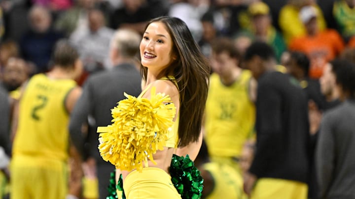 Jan 2, 2025; Eugene, Oregon, USA; Oregon Ducks cheerleader performs during a time out in the second half against the Illinois Fighting Illini at Matthew Knight Arena. Mandatory Credit: Craig Strobeck-Imagn Images Jan 2, 2025; Eugene, Oregon, USA; Oregon Ducks cheerleader performs during a time out in the second half against the Illinois Fighting Illini at Matthew Knight Arena. Mandatory Credit: Craig Strobeck-Imagn Images