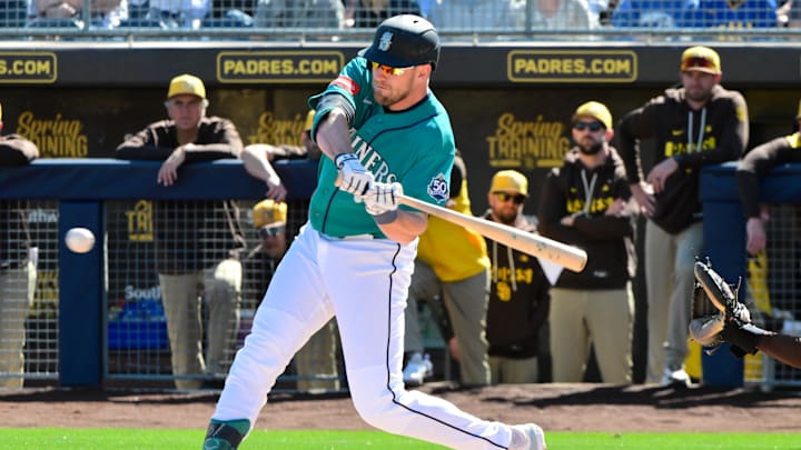 Feb 20, 2026; Peoria, Arizona, USA; Seattle Mariners right fielder Luke Raley (20) singles in the first inning against the San Diego Padres during a Spring Training game at Peoria Sports Complex. Mandatory Credit: Matt Kartozian-Imagn Images