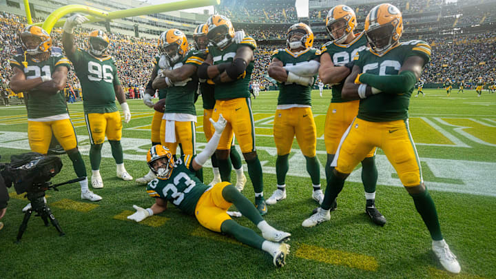 Green Bay Packers safety Evan Williams (33) and his teammate pose for a photo after a fumble recovery during the third quarter of their game Sunday, October 13, 2024 at Lambeau Field in Green Bay, Wisconsin. The Green Bay Packers beat the Arizona Cardinals 34-13.