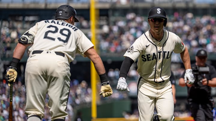 Apr 19, 2026; Seattle, Washington, USA; Seattle Mariners right fielder Rob Refsnyder (30) is congratulated by designated hitter Cal Raleigh (29) after hitting a solo home run during the first inning against the Texas Rangers at T-Mobile Park. Mandatory Credit: Stephen Brashear-Imagn Images