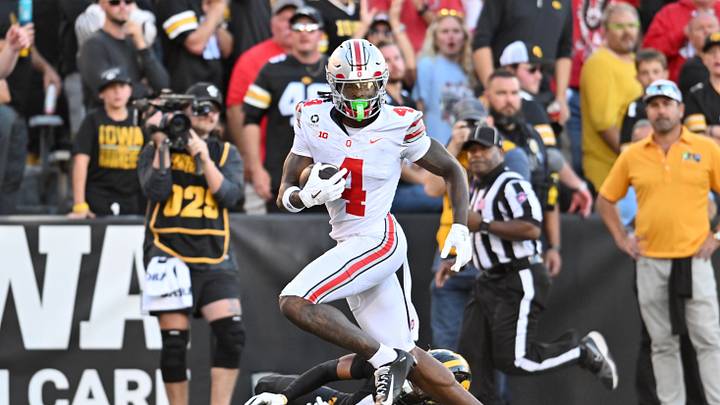 Oct 3, 2026; Iowa City, Iowa, USA; Ohio State Buckeyes wide receiver Jeremiah Smith (4) runs to score a touchdown against Iowa Hawkeyes defensive back Anthony Hawkins (5) during the second half at Kinnick Stadium. Mandatory Credit: Jeffrey Becker-Imagn Images Oct 3, 2026; Iowa City, Iowa, USA; Ohio State Buckeyes wide receiver Jeremiah Smith (4) runs to score a touchdown against Iowa Hawkeyes defensive back Anthony Hawkins (5) during the second half at Kinnick Stadium. Mandatory Credit: Jeffrey Becker-Imagn Images