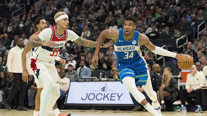 Nov 24, 2023; Milwaukee, Wisconsin, USA;  Milwaukee Bucks forward Giannis Antetokounmpo (34) drives for the basket around Washington Wizards forward Kyle Kuzma (33) during the third quarter at Fiserv Forum. Mandatory Credit: Jeff Hanisch-Imagn Images