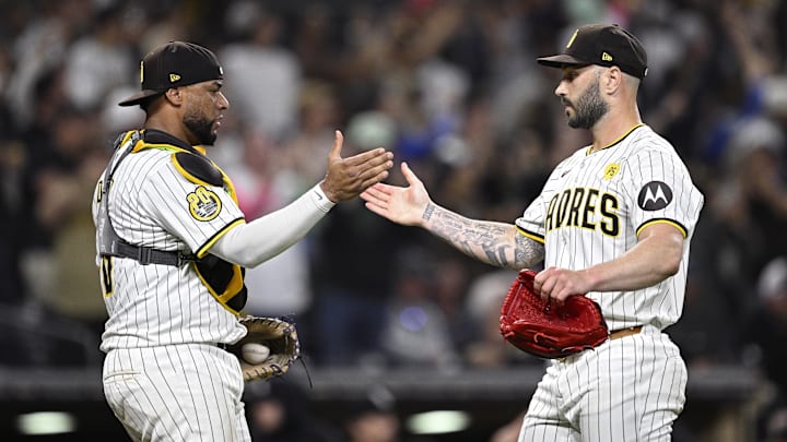 Sep 21, 2024; San Diego, California, USA; San Diego Padres catcher Elias Diaz (left) and relief pitcher Tanner Scott (right) celebrate on the field after defeating the Chicago White Sox at Petco Park. Mandatory Credit: Orlando Ramirez-Imagn Images