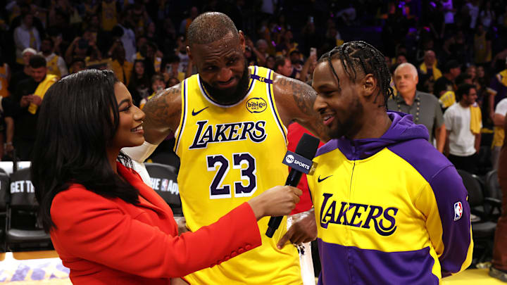 Oct 22, 2024; Los Angeles, California, USA; NBA on TNT sideline reporter Taylor Rooks interviews Los Angeles Lakers forward LeBron James (23) and guard Bronny James (9) after they defeated the Minnesota Timberwolves at Crypto.com Arena.