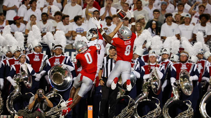 Aug 31, 2024; Tucson, Arizona, USA; Arizona Wildcats wide receiver Tetairoa McMillan (4) attempts to catch ball while New Mexico Lobos center back Bobby Arnold III (0) and New Mexico Lobos safety Christian Ellis (8) deflect the catch during second quarter at Arizona Stadium. Mandatory Credit: Aryanna Frank-Imagn Images