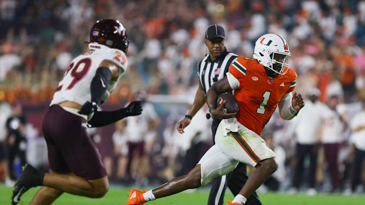Sep 27, 2024; Miami Gardens, Florida, USA; Miami Hurricanes quarterback Cam Ward (1) runs with the football against the Virginia Tech Hokies during the fourth quarter at Hard Rock Stadium. Mandatory Credit: Sam Navarro-Imagn Images