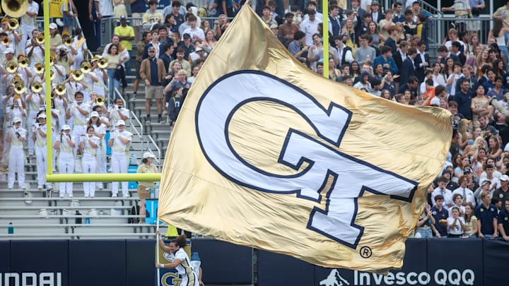 Sep 14, 2024; Atlanta, Georgia, USA; A Georgia Tech Yellow Jackets cheerleader runs a flag after a touchdown against the Virginia Military Institute Keydets in the second quarter at Bobby Dodd Stadium at Hyundai Field. Mandatory Credit: Brett Davis-Imagn Images