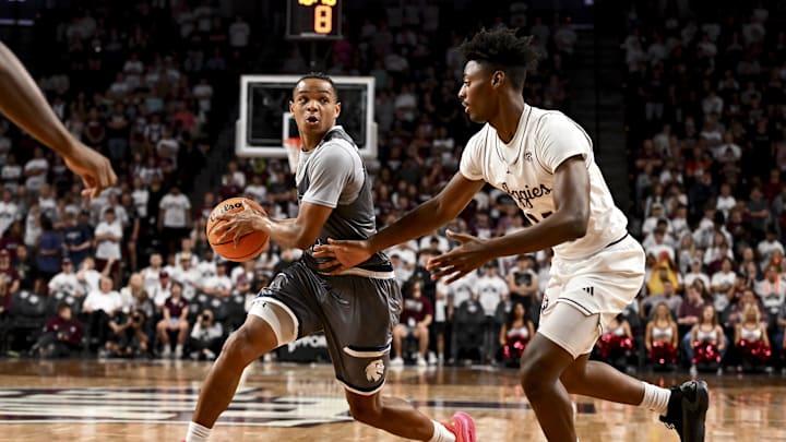 Nov 8, 2024; College Station, Texas, USA; East Texas A&M guard Evan Phelps (2) looks to pass the ball as Texas A&M Aggies forward Chris McDermott (14) defends during the second half at Reed Arena. The Aggies defeated the Lions 87-55. Mandatory Credit: Maria Lysaker-Imagn Images 