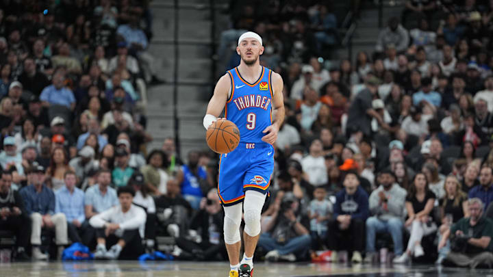 Mar 2, 2025; San Antonio, Texas, USA;  Oklahoma City Thunder guard Alex Caruso (9) dribbles in the second half against the San Antonio Spurs at Frost Bank Center. Mandatory Credit: Daniel Dunn-Imagn Images