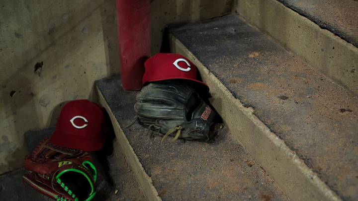 Aug 31, 2026; Cincinnati, Ohio, USA;  On field hats of the Cincinnati Reds are seen on the dugout steps during the game against the San Diego Padres at Great American Ball Park. Mandatory Credit: Aaron Doster-Imagn Images