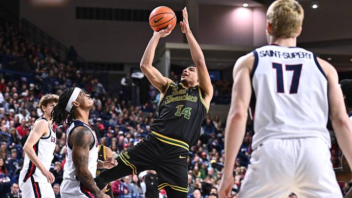 Jan 24, 2026; Spokane, Washington, USA; San Francisco Dons forward Veniamin Abosi (14) shoots the ball against Gonzaga Bulldogs guard Adam Miller (23) in the first half at McCarthey Athletic Center.