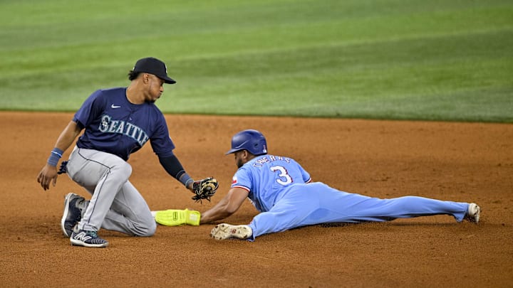Texas Rangers center fielder Leody Taveras (3) slides past the tag of Seattle Mariners second baseman Jorge Polanco (7) during the ninth inning at Globe Life Field in 2024.