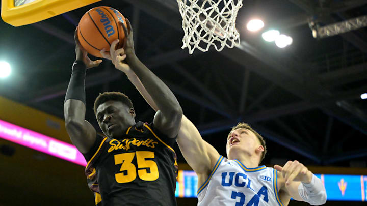 Dec 17, 2025; Los Angeles, California, USA; UCLA Bruins forward Tyler Bilodeau (34) defends Arizona State Sun Devils center Massamba Diop (35) as he drives to the basket in the second half at Pauley Pavilion presented by Wescom Financial. Mandatory Credit: Jayne Kamin-Oncea-Imagn Images 