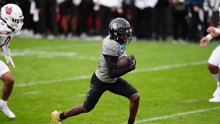 Nov 16, 2024; Boulder, Colorado, USA; Colorado Buffaloes wide receiver Travis Hunter (12) carries for a touchdown in the fourth quarter against the Utah Utes at Folsom Field. Mandatory Credit: Ron Chenoy-Imagn Images