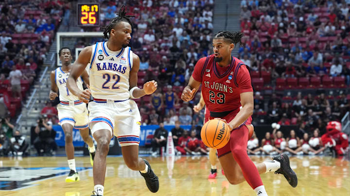 Mar 22, 2026; San Diego, CA, USA; St. John's Red Storm forward Bryce Hopkins (23) controls the ball against Kansas Jayhawks guard Darryn Peterson (22) in the first half during a second round game of the men's 2026 NCAA Tournament at Viejas Arena. Mandatory Credit: Kirby Lee-Imagn Images