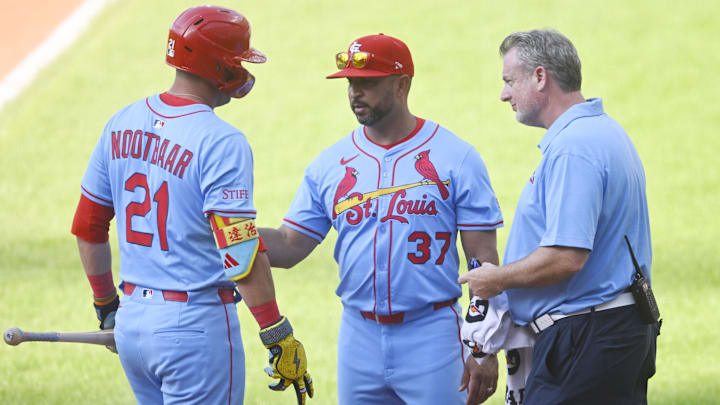 Jun 28, 2025; Cleveland, Ohio, USA; St. Louis Cardinals manager Oliver Marmol (37)(right) and assistant athletic trainer Chris Conroy talk to left fielder Lars Nootbaar (21)(left) after he was hit by a foul ball in the ninth inning against the Cleveland Guardians at Progressive Field. Mandatory Credit: David Richard-Imagn Images Jun 28, 2025; Cleveland, Ohio, USA; St. Louis Cardinals manager Oliver Marmol (37)(right) and assistant athletic trainer Chris Conroy talk to left fielder Lars Nootbaar (21)(left) after he was hit by a foul ball in the ninth inning against the Cleveland Guardians at Progressive Field. Mandatory Credit: David Richard-Imagn Images