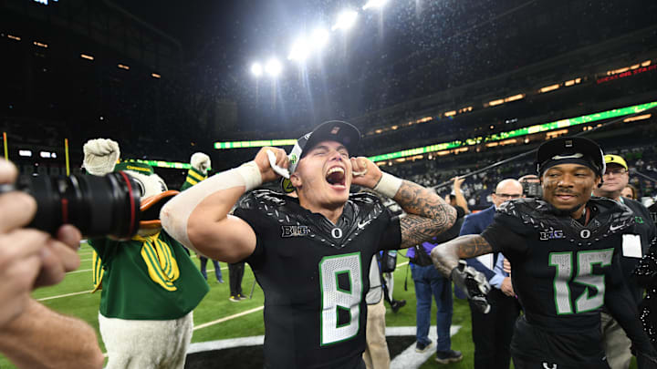 Dec 7, 2024; Indianapolis, IN, USA; Oregon Ducks quarterback Dillon Gabriel (8) and wide receiver Tez Johnson (15) celebrate defeating the Penn State Nittany Lions to win the Big Ten Championship in the 2024 Big Ten Championship game at Lucas Oil Stadium. Mandatory Credit: Robert Goddin-Imagn Images