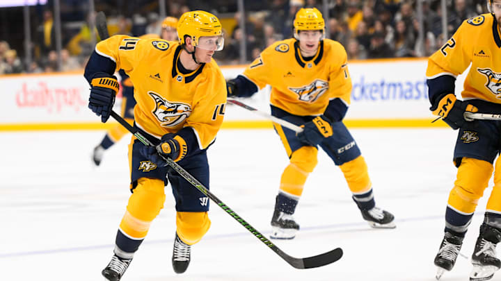 Dec 21, 2024; Nashville, Tennessee, USA;  Nashville Predators center Gustav Nyquist (14) skates with the puck L| during the third period at Bridgestone Arena. Mandatory Credit: Steve Roberts-Imagn Images