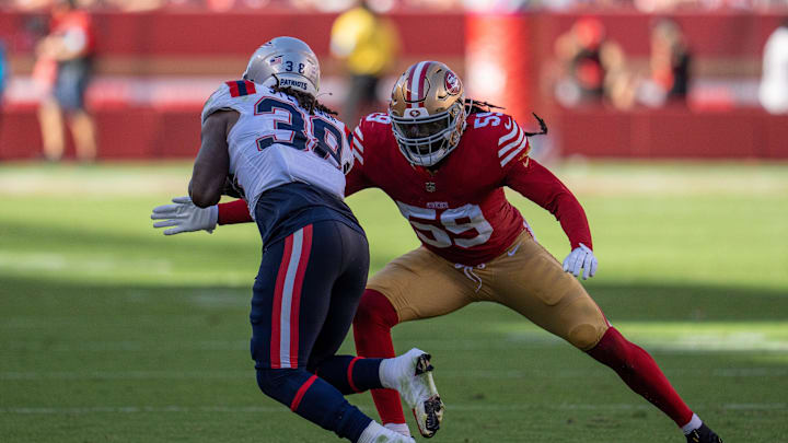 San Francisco 49ers linebacker De'Vondre Campbell (59) tackles New England Patriots running back Rhamondre Stevenson (38) during the fourth quarter at Levi's Stadium. San Francisco 49ers linebacker De'Vondre Campbell (59) tackles New England Patriots running back Rhamondre Stevenson (38) during the fourth quarter at Levi's Stadium.