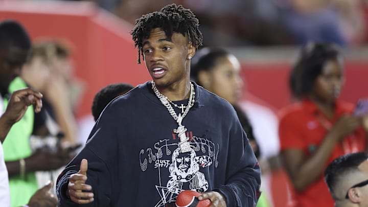 Sep 12, 2025; Houston, Texas, USA; Houston Texans wide receiver Tank Dell talks on the sideine during the game between the Houston Cougars and the Colorado Buffaloes at TDECU Stadium. Mandatory Credit: Troy Taormina-Imagn Images