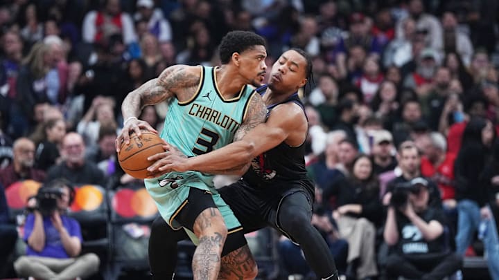 Apr 9, 2025; Toronto, Ontario, CAN; Toronto Raptors forward Scottie Barnes (4) battles for the ball with Charlotte Hornets guard DaQuan Jeffries (3) during the first quarter at Scotiabank Arena. Mandatory Credit: Nick Turchiaro-Imagn Images