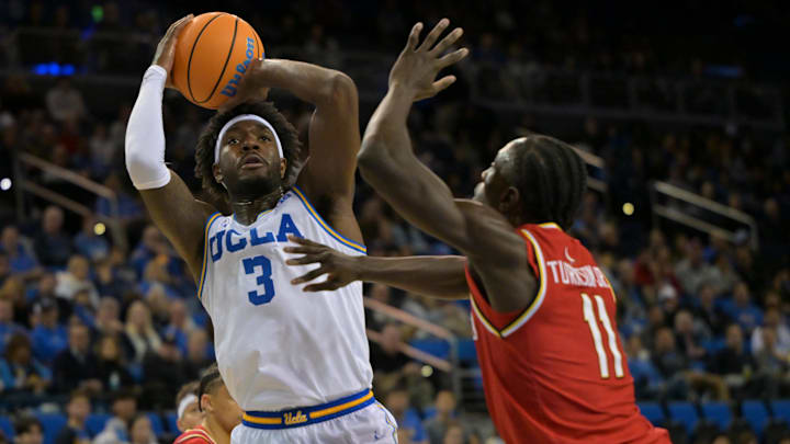 Jan 10, 2026; Los Angeles, California, USA; UCLA Bruins forward Eric Dailey Jr. (3) soots over Maryland Terrapins guard George Turkson Jr. (11) in the second half at Pauley Pavilion presented by Wescom Financial. Mandatory Credit: Jayne Kamin-Oncea-Imagn Images