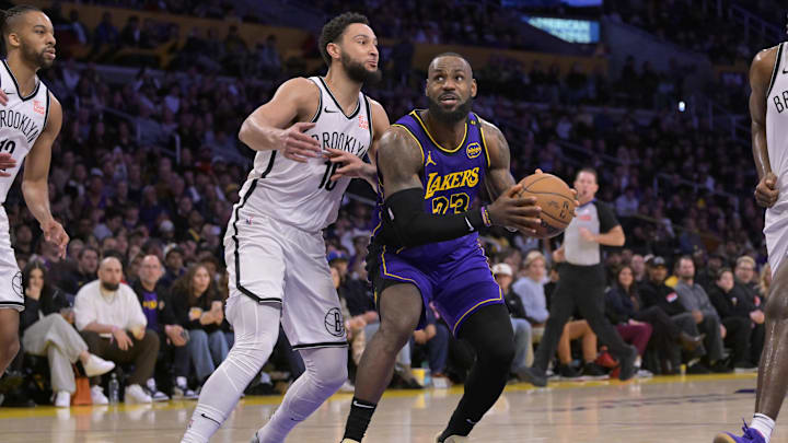 Jan 17, 2025; Los Angeles, California, USA;  Los Angeles Lakers forward LeBron James (23) is defended by Brooklyn Nets guard Ben Simmons (10) as he takes the ball down court in the second half at Crypto.com Arena. Mandatory Credit: Jayne Kamin-Oncea-Imagn Images