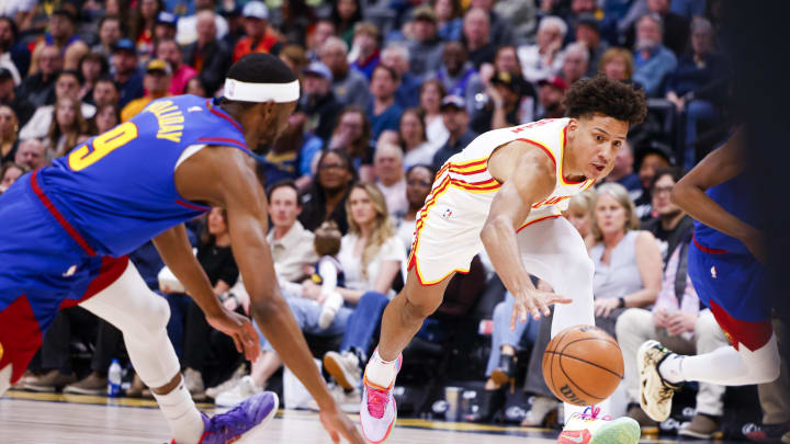 Apr 6, 2024; Denver, Colorado, USA; Atlanta Hawks forward Jalen Johnson (1) and Denver Nuggets forward Justin Holiday (9) scramble for a loose ball in the first half at Ball Arena. Mandatory Credit: Michael Ciaglo-USA TODAY Sports