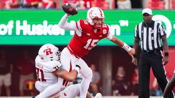 Oct 5, 2024; Lincoln, Nebraska, USA; Nebraska Cornhuskers quarterback Dylan Raiola (15) is sacked by Rutgers Scarlet Knights defensive lineman Aaron Lewis (71) during the fourth quarter at Memorial Stadium. Mandatory Credit: Dylan Widger-Imagn Images