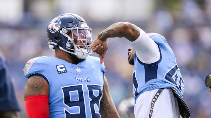 Sep 22, 2024; Nashville, Tennessee, USA;  Tennessee Titans defensive tackle Jeffery Simmons (98) and linebacker Arden Key (49) get fired up against the Green Bay Packers during pregame warmups at Nissan Stadium. Mandatory Credit: Steve Roberts-Imagn Images
