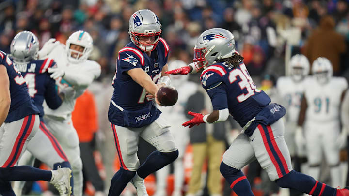 Jan 4, 2026; Foxborough, Massachusetts, USA; New England Patriots quarterback Drake Maye (10) hands the ball off to running back Rhamondre Stevenson (38) against the Miami Dolphins during the first quarter at Gillette Stadium. Mandatory Credit: David Butler II-Imagn Images Jan 4, 2026; Foxborough, Massachusetts, USA; New England Patriots quarterback Drake Maye (10) hands the ball off to running back Rhamondre Stevenson (38) against the Miami Dolphins during the first quarter at Gillette Stadium. Mandatory Credit: David Butler II-Imagn Images