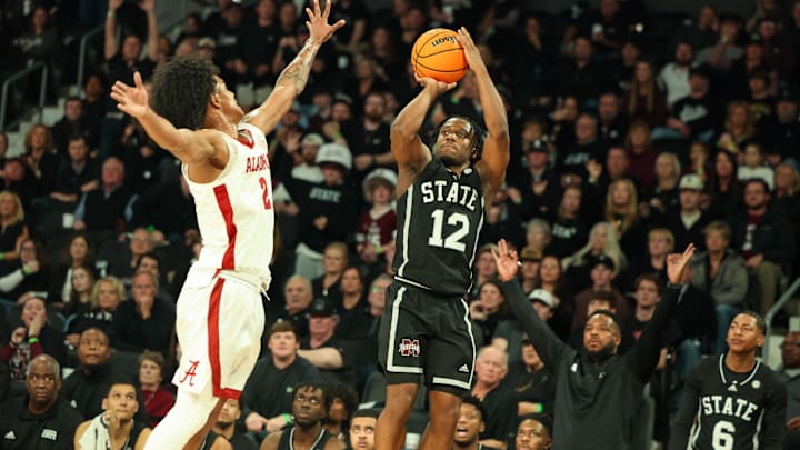 Jan 29, 2025; Starkville, Mississippi, USA; Mississippi State Bulldogs guard Josh Hubbard (12) shoots as Alabama Crimson Tide guard Aden Holloway (2) defends during the second half at Humphrey Coliseum. Mandatory Credit: Wesley Hale-Imagn Images