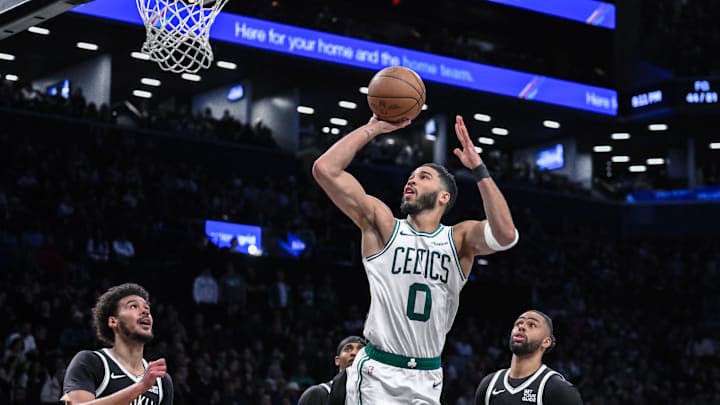 Mar 15, 2025; Brooklyn, New York, USA; Boston Celtics forward Jayson Tatum (0) shoots the ball while being defended by Brooklyn Nets forward Cameron Johnson (2) during the second half at Barclays Center. Mandatory Credit: John Jones-Imagn Images