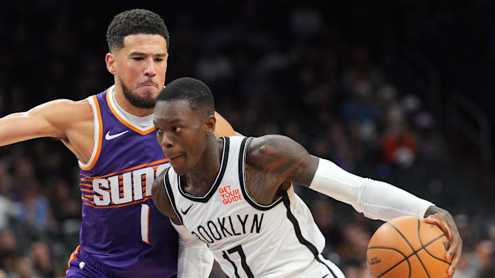 Nov 27, 2024; Phoenix, Arizona, USA; Brooklyn Nets guard Dennis Schroder (17) dribbles against Phoenix Suns guard Devin Booker (1) during the second half at Footprint Center. Mandatory Credit: Joe Camporeale-Imagn Images