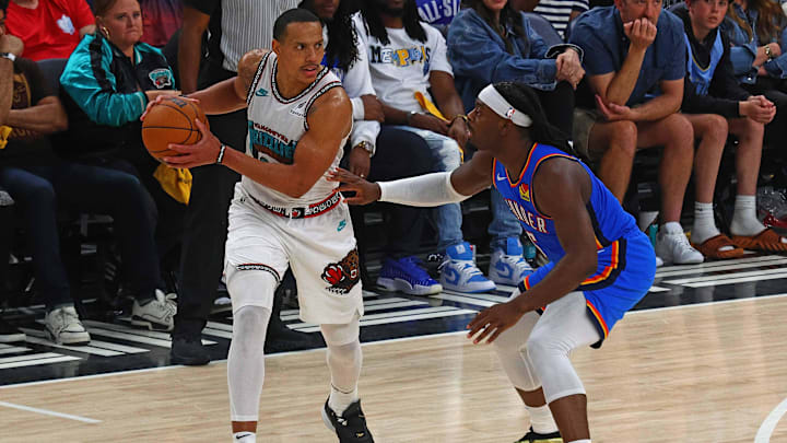Apr 24, 2025; Memphis, Tennessee, USA; Memphis Grizzlies guard Desmond Bane (22) handles the ball as Oklahoma City Thunder guard Luguentz Dort (5) defends during the third quarter during game three for the first round of the 2025 NBA Playoffs at FedExForum. Mandatory Credit: Petre Thomas-Imagn Images