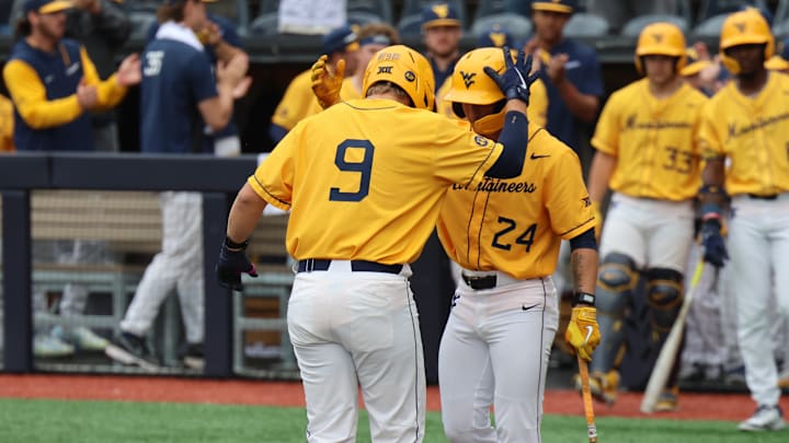 West Virginia University first baseman is greeted by third baseman Chase Swain after a solo home run against Texas Tech. West Virginia University first baseman is greeted by third baseman Chase Swain after a solo home run against Texas Tech.