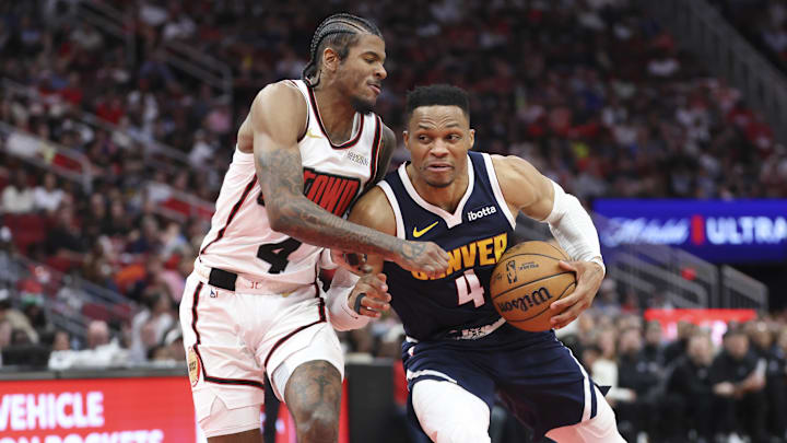 Mar 23, 2025; Houston, Texas, USA; Houston Rockets guard Jalen Green (4) defends as Denver Nuggets guard Russell Westbrook (4) controls the ball during the fourth quarter at Toyota Center. Mandatory Credit: Troy Taormina-Imagn Images